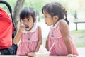 Two little girls eat ice cream together Royalty Free Stock Photo