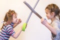 Two little girls are fighting on swords Royalty Free Stock Photo