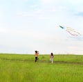 Two little girls fly a kite Royalty Free Stock Photo