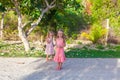 Two little girls on footpath in a tropical country Royalty Free Stock Photo