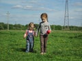 Two little girls go hand in hand