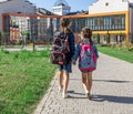 Two little girls go to school, holding hands, back view Royalty Free Stock Photo