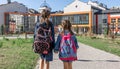 Two little girls go to school, holding hands, back view Royalty Free Stock Photo