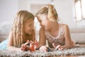 Two little girls having her nails painted at home.