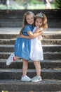 Two little girls hugging. Happy funny girl sisters hugging and laughing