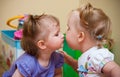 Two little girls kissing