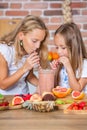 Two little girls in the kitchen with fresh vegetables. Healthy food concept. Royalty Free Stock Photo