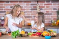 Two little girls in the kitchen with fresh vegetables. Healthy food concept. Royalty Free Stock Photo