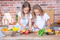 Two little girls in the kitchen with fresh vegetables. Healthy food concept. Royalty Free Stock Photo