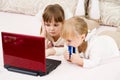 Two little girls are with a laptop Royalty Free Stock Photo