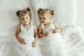 Two Little Girls Laying on a Bed Together Royalty Free Stock Photo