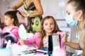 Two little girls in a make-up studio.