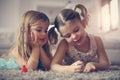 Girl stuff. Little girls on floor. Royalty Free Stock Photo