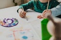 Two little girls are painting on the table. Kids are sisters or classmates. Royalty Free Stock Photo