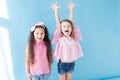Two little girls in pink clothing girlfriends laugh Royalty Free Stock Photo