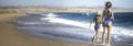 Two little girls play along the beach by the sea. Royalty Free Stock Photo