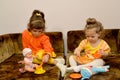 Two little girls play house