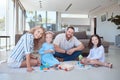 Two little girls playing with colourful building blocks while sitting at home with parents. Couple playing with their Royalty Free Stock Photo