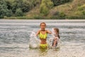 Two little girls playing in the lake