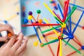 Two little girls playing with lots of colorful plastic sticks kit indoors. kids having fun with building geometric figures and l Royalty Free Stock Photo