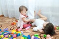 Two little girls playing. Sisters - baby and toddler play constructor toys Royalty Free Stock Photo