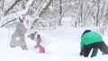 Two little girls playing with their friend in the snow in winter forest. Royalty Free Stock Photo