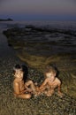 Two little girls playing in water at seaside Royalty Free Stock Photo