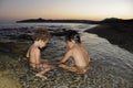 Two little girls playing in water at seaside Royalty Free Stock Photo