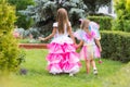 Two little girls, princess and fairy strolling through the garden Royalty Free Stock Photo