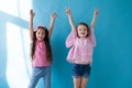 Two little girls raise their hands up Royalty Free Stock Photo