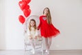 Two little girls with red balloons on Valentine`s Day Royalty Free Stock Photo