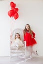 Two little girls with red balloons on Valentine`s Day Royalty Free Stock Photo