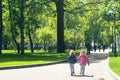 Two little girls run to the park after quarantine, sisters run through the park in spring, walks during the epidemic Royalty Free Stock Photo