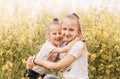 Two little girls sisters cuddle in nature in summer Royalty Free Stock Photo
