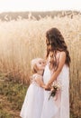 Two little girls sisters hug and collect flowers in the summer Royalty Free Stock Photo