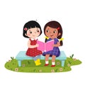 Two little girls sitting on the bench and reading book together Royalty Free Stock Photo