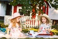 Two little girls sitting on green grass Royalty Free Stock Photo