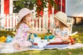 Two little girls sitting on green grass Royalty Free Stock Photo