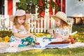 Two little girls sitting on green grass Royalty Free Stock Photo