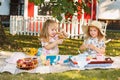 Two little girls sitting on green grass Royalty Free Stock Photo