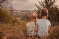 Two little girls sitting together in the tall grass Royalty Free Stock Photo