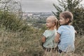 Two little girls sitting together in the tall grass Royalty Free Stock Photo