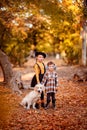 Girls walking Golden Retriever in autumn Park. Royalty Free Stock Photo