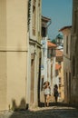 Two little girls walking up the alley on slope with old houses Royalty Free Stock Photo