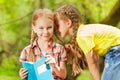 Two little girls whispering secrets in the ear Royalty Free Stock Photo