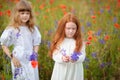 Two little girls in white dress playing in poppy flower field. C Royalty Free Stock Photo