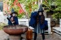 Two little girls in witch costumes brew a magic drink in an abandoned old building. Halloween concept