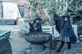 Two little girls in witch costumes brew a magic drink in an abandoned old building. Halloween concept. Toned