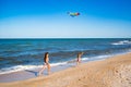 Two little happy cheerful girls run with a kite Royalty Free Stock Photo