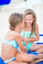 Two little happy girls have a lot of fun at tropical beach playing together Royalty Free Stock Photo